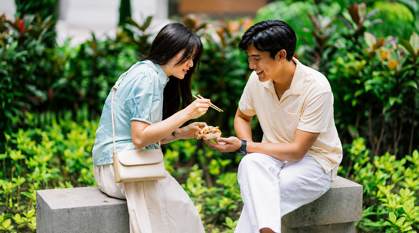 Couple sharing food outdoors after meeting through a local meetup